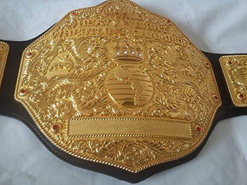 Gold championship belt with intricate designs on a white background