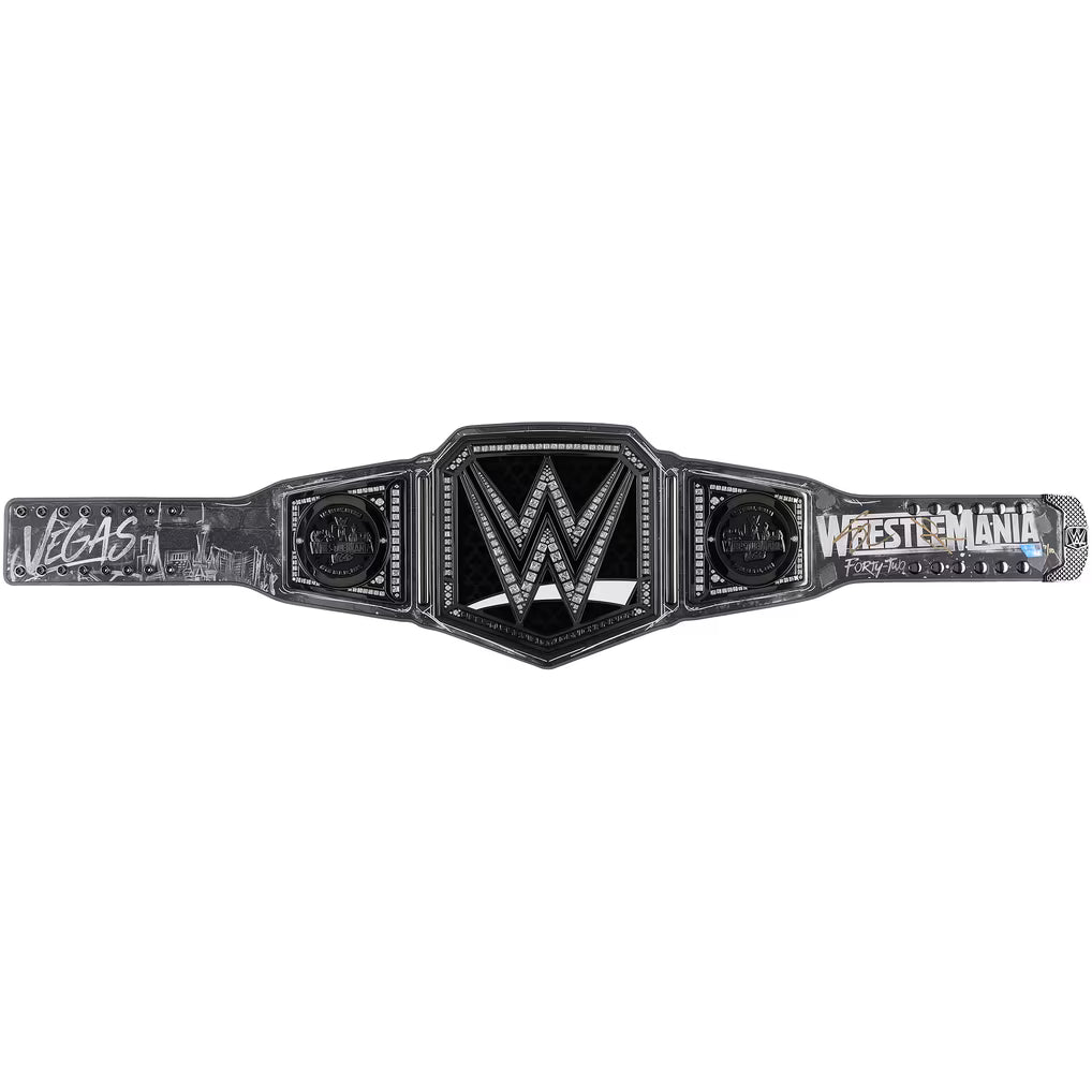 WrestleMania Las Vegas 2024 WWE Championship belt shown flat against a white background, featuring a black and silver central plate with the WWE logo and 'WrestleMania' text on the straps.