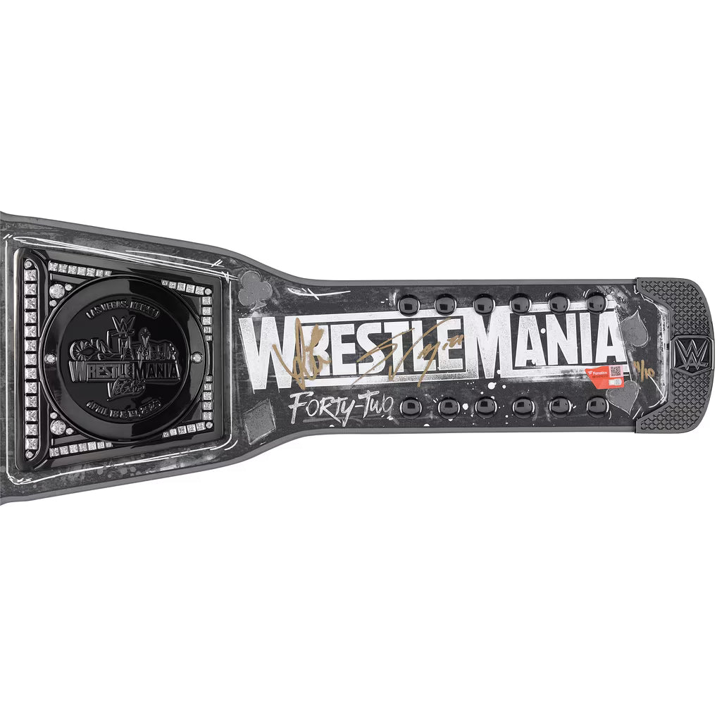 WrestleMania Forty-Two championship belt buckle and strap, featuring a black and silver design with distressed white lettering and gold and red accents, shown on a plain white background.