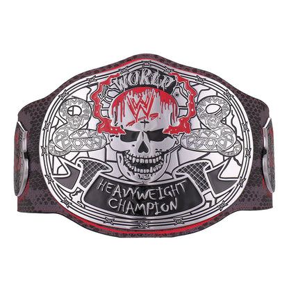 Wrestling championship belt featuring a large central skull emblem with WWE branding, flanked by two smaller skulls and crossed axes, on a dark textured strap with red and black detailing.
