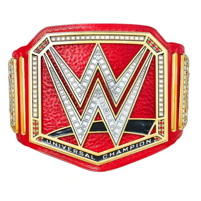 WWE Universal Champion belt featuring a red textured leather strap, a large silver 'W' logo outlined in gold, rhinestone accents, and 'UNIVERSAL CHAMPION' text on a white background.