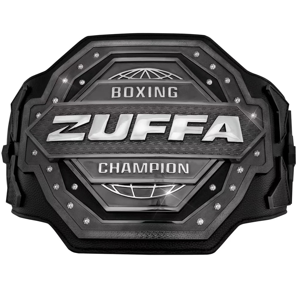 A black and silver Zuffa Boxing Champion belt with textured metallic plates, silver lettering, and small rhinestone accents, shown on a plain white background.