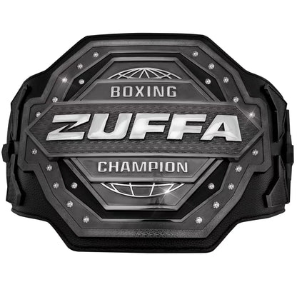 A black and silver Zuffa Boxing Champion belt with textured metallic plates, silver lettering, and small rhinestone accents, shown on a plain white background.