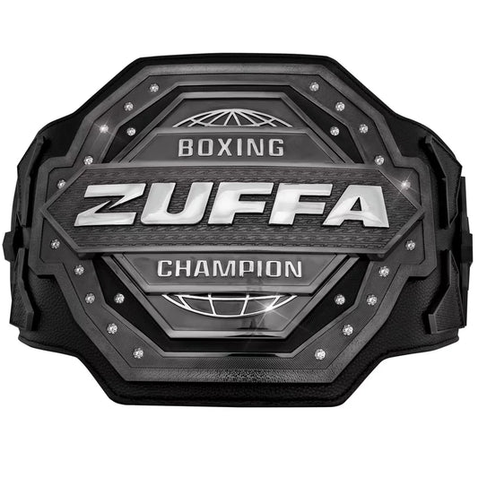A black and silver Zuffa Boxing Champion belt with textured metallic plates, silver lettering, and small rhinestone accents, shown on a plain white background.