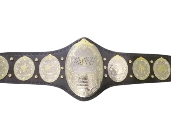 A championship belt with a black textured strap and multiple oval and round gold-toned and silver-toned medallions, including a large central AEW logo plate, shown against a plain white background.