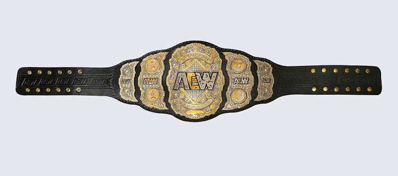 A black leather championship belt with ornate gold and silver metal plates, featuring the AEW (All England Wrestling) logo in the center, shown against a light gray background.
