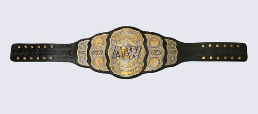 A black leather championship belt with ornate gold and silver metal plates, featuring the AEW (All England Wrestling) logo in the center, shown against a light gray background.