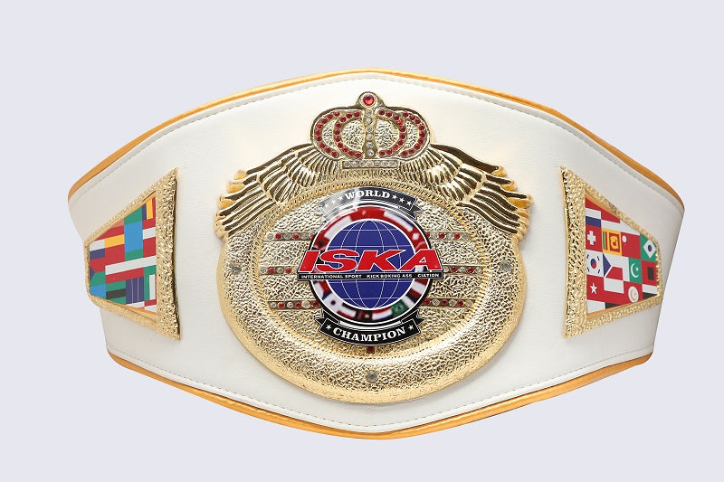 A white and gold ISKA World Champion belt with detailed gold winged emblems, a central globe medallion, and colorful international flag panels on the sides, shown against a light gray background.