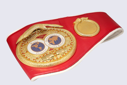 A red boxing championship belt with a large gold snake coiling around the center, featuring two circular medallions with the words 'The International Boxing Series' and 'Champion'.