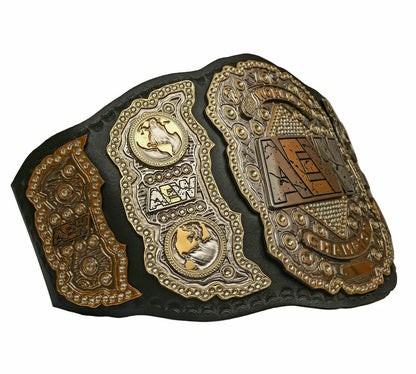 Decorative belt with gold and black design on a white background