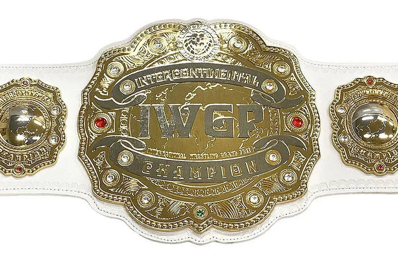 An ornate championship belt with a large central gold-toned plate reading 'IVGP' and 'Intercontinental Champion,' flanked by two matching side plates on a white strap, photographed on a plain white background.