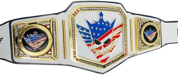A custom wrestling championship belt featuring a central plate with a skull wearing an American flag crown, flanked by two side plates with eagle emblems, all on a white strap with gold trim.