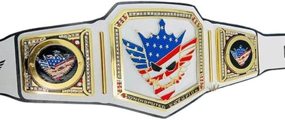 A custom wrestling championship belt featuring a central plate with a skull wearing an American flag crown, flanked by two side plates with eagle emblems, all on a white strap with gold trim.