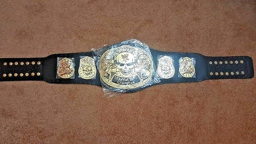 Wrestling championship belt with a plastic cover on a brown surface