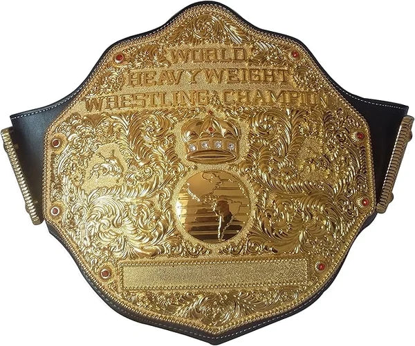 An ornate gold championship belt with black leather straps, featuring intricate embossed details, a crown motif, and the text 'WORLD HEAVYWEIGHT WRESTLING CHAMPION' on a plain white background.