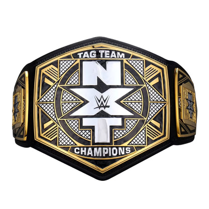 WWE NXT Tag Team Champions belt featuring a black and gold hexagonal design with a large white 'NXT' logo in the center, on a plain white background.