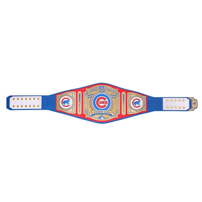 A Chicago Cubs championship belt laid flat against a solid white background. The belt is royal blue with red and gold plates, featuring the Cubs 'C' logo and 'Cubs' branding.