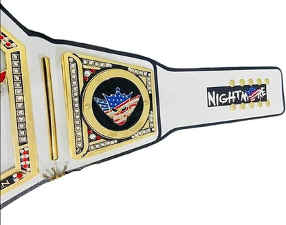 A close-up of a wrestling championship belt strap with a white leather-like base, gold-tone metal plates, black trim, and a central emblem featuring an American flag motif. The right side shows the text 'NIGHTMARE' in white on a black background with gold dots.