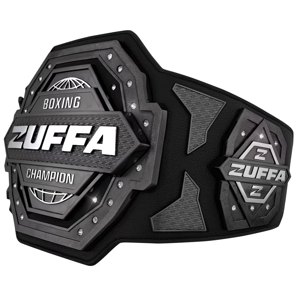 A black and gray Zuffa boxing championship belt with silver lettering and studs, shown on a plain white background.
