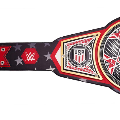 A WWE USA Championship belt shown in a close-up side view against a white background, featuring a black strap with red and white star patterns, a red WWE logo, and a central gold, red, and black plate with 'USA' and a shield emblem.