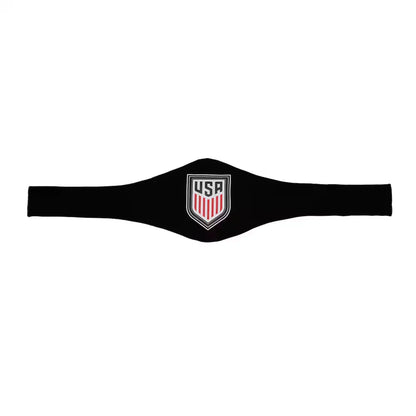 A black athletic headband featuring a central USA shield logo with red and white vertical stripes and a silver border, displayed against a solid white background.