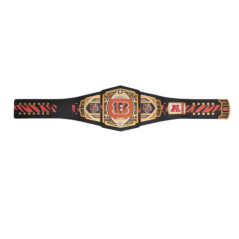 A championship belt with a black strap and ornate gold, red, and silver plates, featuring a central plate with a red 'TF' logo and side plates with 'ML' and other decorative emblems.
