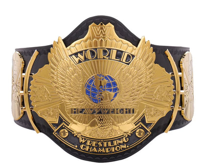 A gold and black WWE Heavyweight Championship belt with an ornate eagle design and blue globe emblem on the center plate, isolated on a white background.
