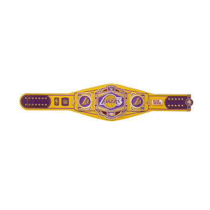 A replica Los Angeles Lakers championship belt featuring a yellow strap with purple and gold metallic-style detailing, centered on a plain white background.