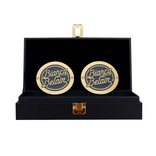 Gold cufflinks with 'Bianco Belair' branding in a black box on a white background Bianca Belair 16MM Replica Side Plate Box Set