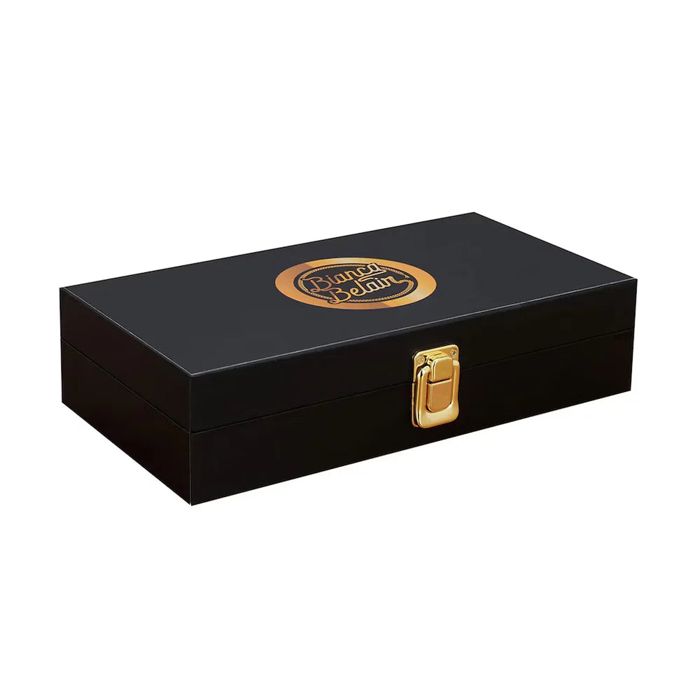 Black jewelry box with gold accents and a visible brand logo on a white background Bianca Belair 16MM Replica Side Plate Box Set