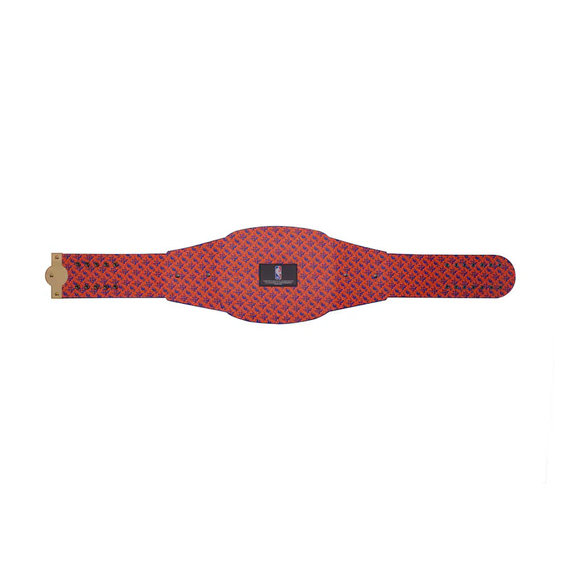 Red patterned belt with a gold buckle on a white background