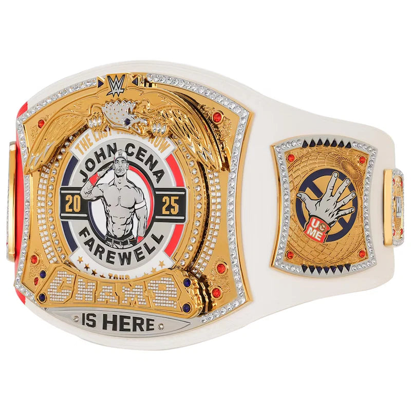 A WWE John Cena Farewell Championship belt featuring a white strap with ornate gold-toned plates, crystal accents, and red details. The center plate displays 'JOHN CENA' with a graphic of the wrestler and the numbers 20 and 25, while the right plate shows a hand graphic with a red and blue WWE logo.