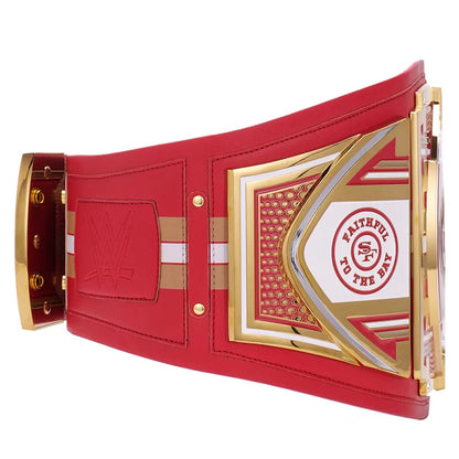 Red and gold championship belt with a central emblem on a white background