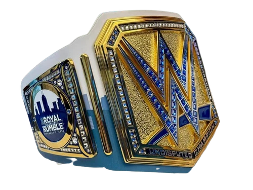 A custom WWE Royal Rumble championship belt featuring a large gold and blue central plate with a textured gold 'W' and blue accents, a smaller blue and gold side plate with the 'Royal Rumble' logo, and a white strap base.