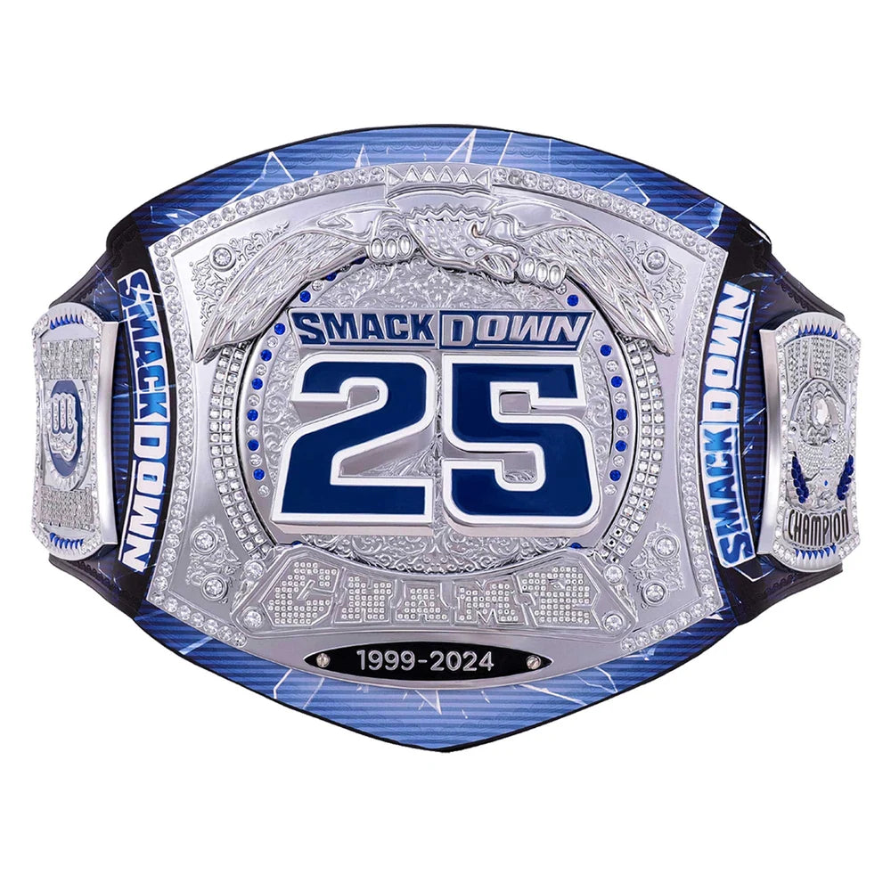 A custom championship belt featuring a large silver-toned central plate with blue and silver details, the number 25, and 'SMACKDOWN' text, flanked by blue and silver straps on a white background.