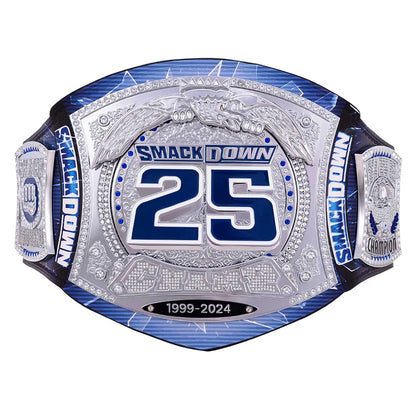 A custom championship belt featuring a large silver-toned central plate with blue and silver details, the number 25, and 'SMACKDOWN' text, flanked by blue and silver straps on a white background.