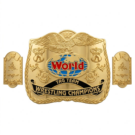 A gold-colored championship belt plaque with two side plates, featuring an eagle at the top, a blue and red globe with the text 'World' in red, and a black banner reading 'TAG TEAM WRESTLING CHAMPIONS'.