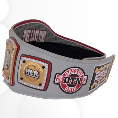 Gray championship belt with various logos and text on a white background