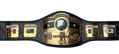 A black leather wrestling championship belt with a large gold central plate reading 'Worlds Heavyweight Champion' and 'U.S.