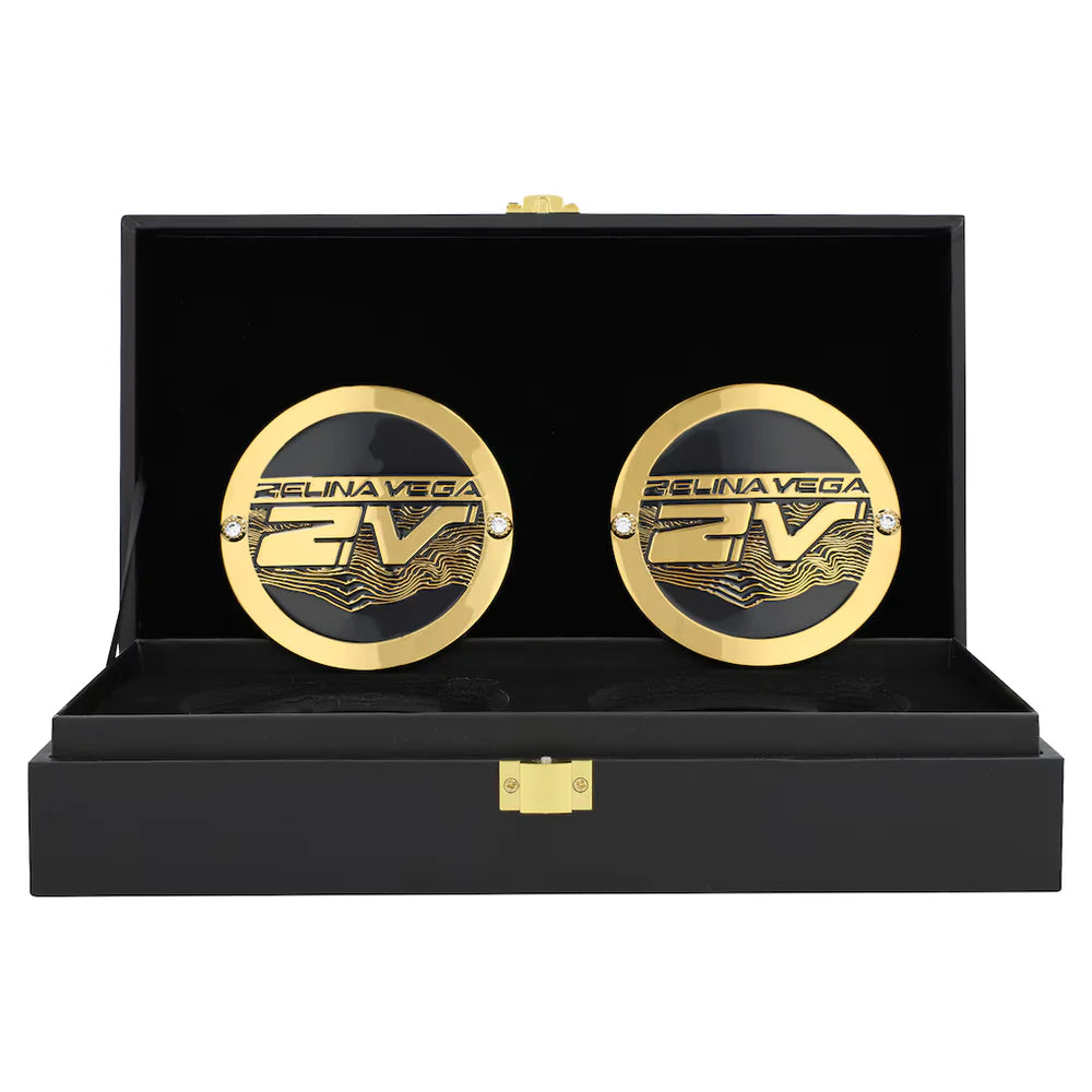 Gold cufflinks with 'Fели娜 Vega' branding in a black display box.