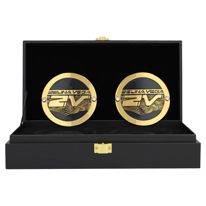 Gold cufflinks with 'Fели娜 Vega' branding in a black display box.