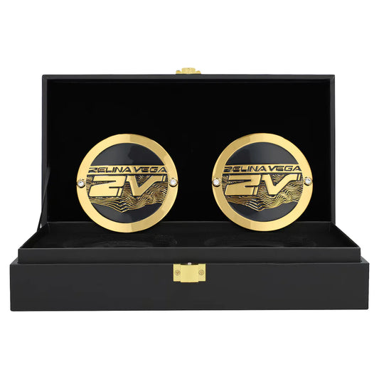 Gold cufflinks with 'Fели娜 Vega' branding in a black display box.
