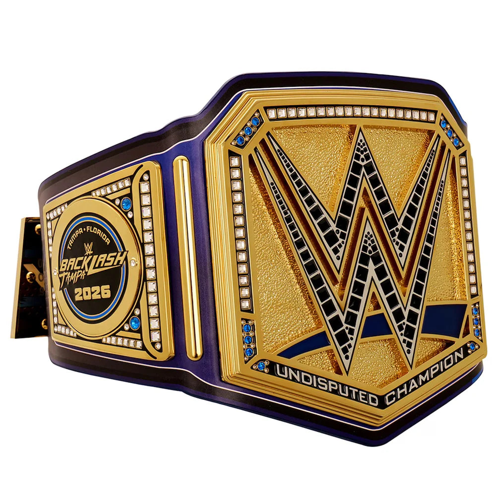 A WWE Undisputed Champion belt with a gold and purple design, featuring a large 'W' logo on the front plate and a circular 'Back in the Main Event 2025' medallion on the side, shown on a white background.