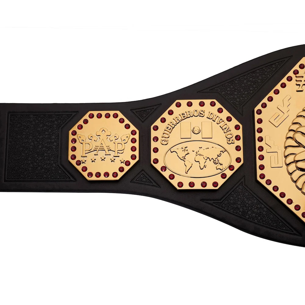 A close-up of a black championship-style belt with gold-toned plates and red dot accents, showing embossed designs including 'Dad' and 'Nuevamos Invígos' on a white background.