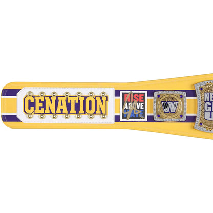 A yellow and purple wrestling championship belt with gold lettering reading 'CENATION' on a white panel, alongside a 'Rise Above' patch and a WWE-style medallion, shown against a plain white background.