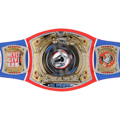 A custom championship belt featuring a gold central plate with a spinning disc in the middle, flanked by blue side panels with red borders and gold emblems. The left panel reads 'NEVER GIVE UP' and the right panel reads 'UP ME'.