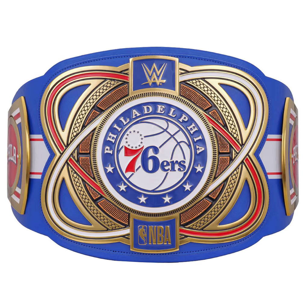 A replica Philadelphia 76ers WWE championship belt featuring a royal blue leather strap with ornate gold, red, and white metal-style plates. The center plate displays the Philadelphia 76ers logo with WWE branding at the top and an NBA logo at the bottom.