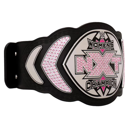WWE Women's NXT Champion belt featuring a black strap with a large silver and black central plate embellished with pink rhinestones, flanked by matching pink rhinestone sections on a white background.