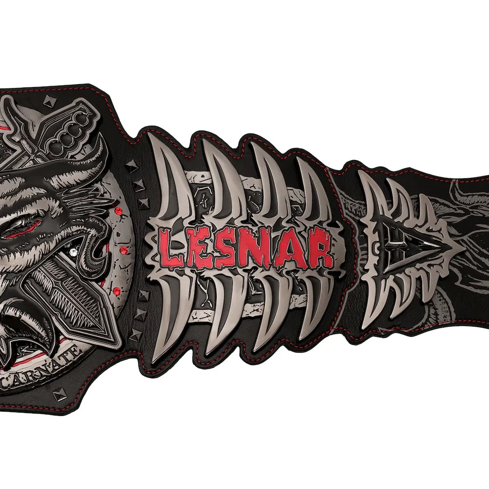 A close-up of a black and silver leather belt featuring a detailed wolf head buckle on the left, sharp metallic teeth motifs across the center, and the brand name 'LESNAR' in red text, set against a plain white background.