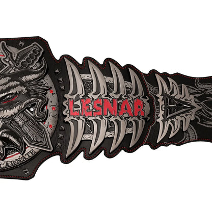 A close-up of a black and silver leather belt featuring a detailed wolf head buckle on the left, sharp metallic teeth motifs across the center, and the brand name 'LESNAR' in red text, set against a plain white background.